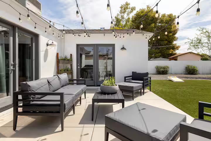 Stylish & Perfect for Families covered patio lounge at a direct-booking vacation rental in Phoenix, Arizona