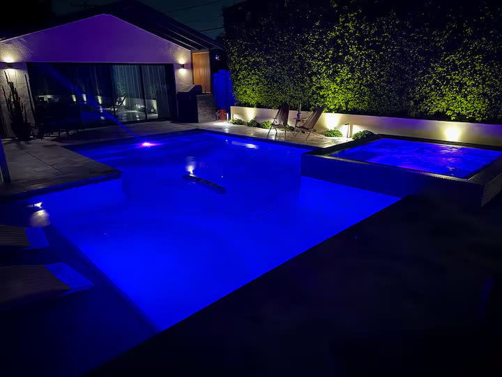 Palm Haven Pool House pool at night at a direct-booking vacation rental in Phoenix, Arizona