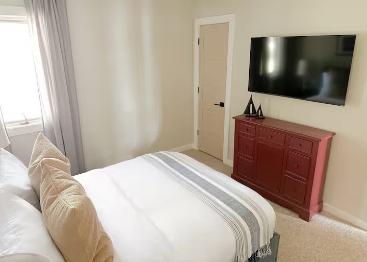 The Angler's Canoe Lake House primary bedroom at a direct-booking vacation rental in Cedar Bluff, Alabama
