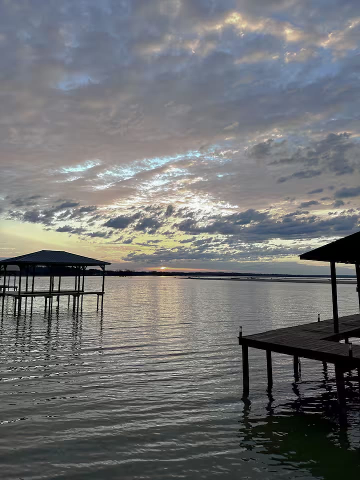 The Angler's Canoe Lake House lakefront seating at a direct-booking vacation rental in Cedar Bluff, Alabama