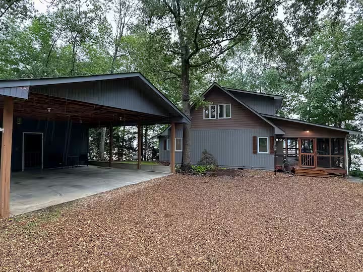 The Angler's Canoe Lake House covered carport at a direct-booking vacation rental in Cedar Bluff, Alabama